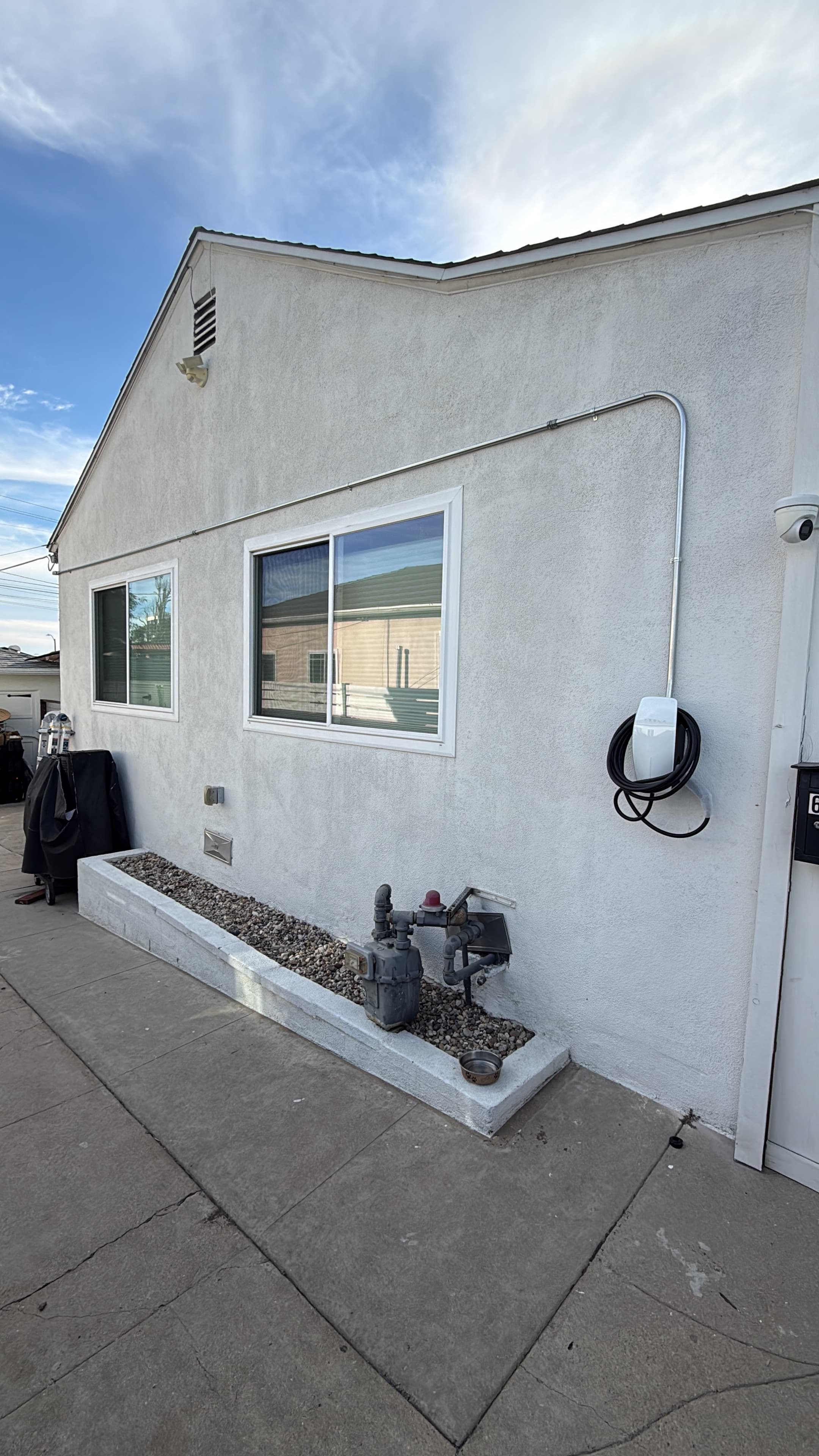 Exterior conduit run from the load center to the charger location.