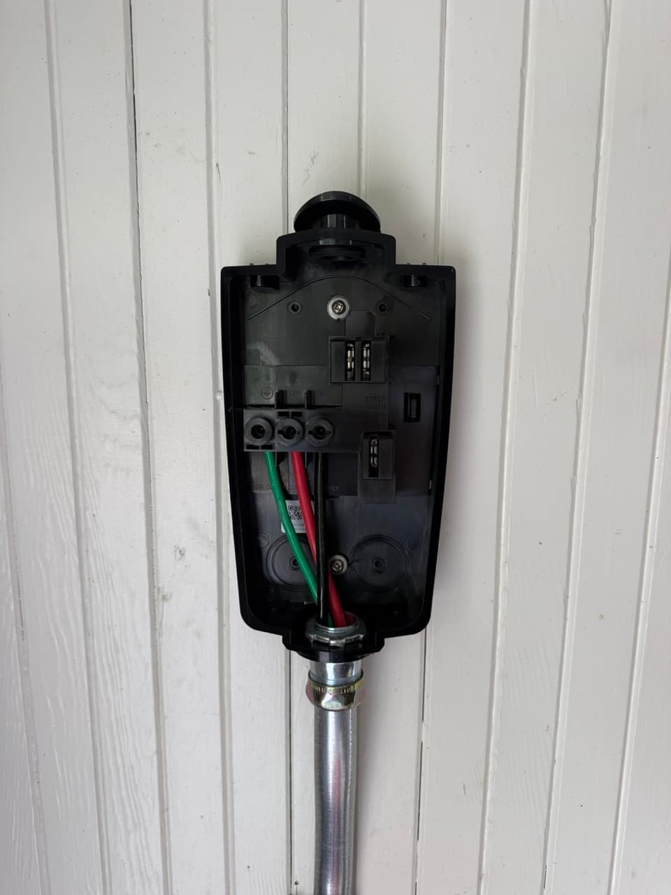 Charger mounted and terminated at the garage wall.